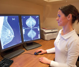 Radiology technician examines mammography test