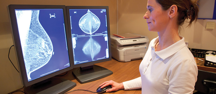 Radiology technician examines mammography test