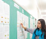 Female student checking a noticeboard